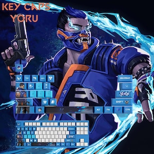 May include: Blue and white keyboard keycaps with a Yoru theme from the game Valorant. The keycaps feature the character's image and name. The keyboard is blue and white with various keycap designs. The text "KEY CAPS YORU" is visible at the top.