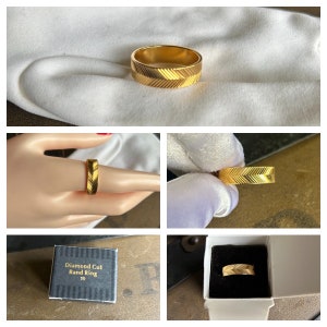 May include: A gold band ring with a diamond cut design. The ring is in a small box with the words "Diamond Cut Band Ring 10" printed on the box.