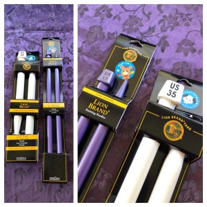May include: Three sets of double-pointed knitting needles in different sizes and colors. The needles are packaged in black and white cardboard with the brand name "Lion Brand" printed on them. The needles are labeled with the US sizes 17, 35, and 35. The needles are purple, white, and white.
