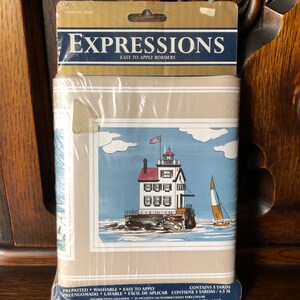 May include: A package of Expressions easy-to-apply wallpaper border featuring a lighthouse with a sailboat in the foreground. The border is prepasted, washable, and contains 5 yards (4.5 meters).