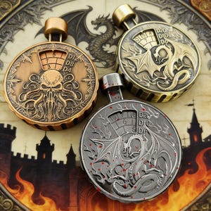 May include: Three metal dice rollers with detailed designs. One depicts Cthulhu, another a dragon, and the third a dragon with blood splatter. Each has a numbered display for D&D dice rolls. The rollers are bronze, silver, and gold.
