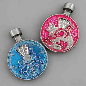 May include: Two metal dice rollers with a silver finish. One is blue with an octopus design, the other is pink with a dragon. Each has a numbered dial for D4, D8, D12, and D20 dice.