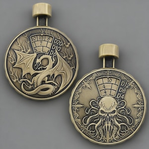 May include: Two bronze-coloured pendants with a loop at the top. One pendant features a dragon with dice numbers, the other has an octopus-like creature with dice numbers. The pendants are likely for role-playing games.