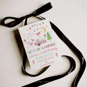 May include: A white invitation card with the text "LET'S GO GLAMPING!" and a colorful illustration of a camper, flamingo, and trees. The card is tied with a black ribbon. The invitation is for Lauren's Sixth Birthday.