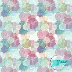 May include: Abstract watercolor pattern featuring overlapping circles in shades of pink, purple, green, and blue. White curved lines and a light blue background create a dreamy effect. The image includes the text "Shacie STUDIO".