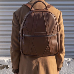 Lifestyle photo of brown leather work school backpack