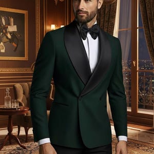 May include: A dark green tuxedo jacket with a black satin lapel, paired with a white dress shirt and black bow tie. The formal wear ensemble is completed with black trousers. The setting is an elegant room with a painting and a window.