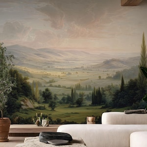 May include: A scenic landscape mural depicting a valley with rolling hills, trees, and a cloudy sky. The color palette includes greens, browns, and soft pastels, creating a serene and naturalistic scene. The mural is likely designed for interior wall decor.