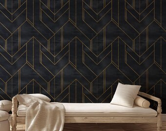 May include: A dark blue and gold geometric wallpaper with a chevron pattern. The wallpaper is paired with a light wood daybed, a beige throw blanket, and white pillows. The room has a modern, minimalist aesthetic.