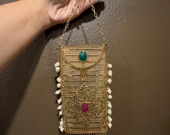 Brass hand bag perfect for mobile phones. Easy to carry. Made with brass material. Can be tucked in skirts , saree lehenga , suits etc