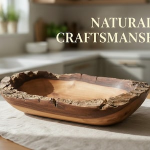 May include: A wooden bowl with a natural, textured edge, featuring a light brown interior and a darker rim. The text "NATURAL CRAFTSMANSHIP" is displayed above the bowl. This handcrafted bowl is ideal for serving or display.