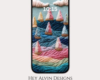 May include: A smartphone displaying a digital wallpaper featuring an embroidered-style scene of sailboats on a textured sea. The screen shows the date June 24 and the time 10:15. Below the phone, the text reads HEY ALVIN DESIGNS with a small dog icon.
