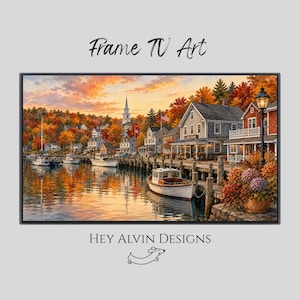 May include: A digital print titled Frame TV Art by Hey Alvin Designs featuring a coastal harbor scene at sunset with white boats, wooden docks, shingled buildings, and autumn foliage. A black lamp post stands near a potted plant in the foreground.