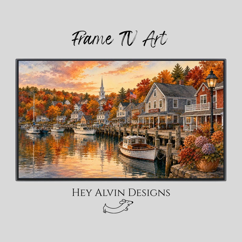 May include: A digital print titled Frame TV Art by Hey Alvin Designs featuring a coastal harbor scene at sunset with white boats, wooden docks, shingled buildings, and autumn foliage. A black lamp post stands near a potted plant in the foreground.