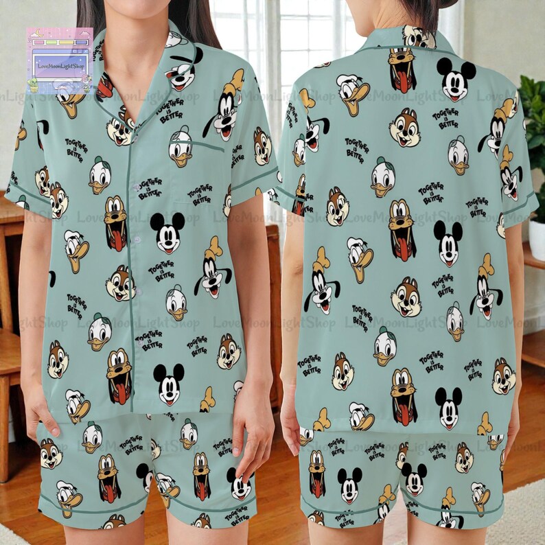 A woman wearing a light blue pajama top with a repeating pattern of cartoon character faces, including Mickey Mouse, Goofy, Donald Duck, and others.