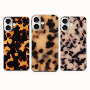 May include: Three phone cases with a tortoiseshell design. The cases have a clear edge and a shiny finish. The patterns vary in colour, with shades of brown, black, and cream. The cases are designed for a smartphone.