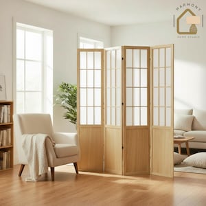 May include: A four-panel wooden room divider with a light wood finish. Each panel features a grid of small, rectangular windows with translucent inserts. The divider stands in a well-lit room with a neutral color palette, suggesting a minimalist or modern interior design.