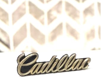 Vintage Cadillac Grill Emblem: Gold Script on Black, OEM Radiator Badge (1980-1992)