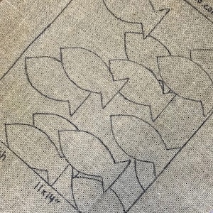 May include: A burlap fabric with a pattern of fish shapes printed on it. The fabric is labeled "11 1/4 in. Hi-Rise".