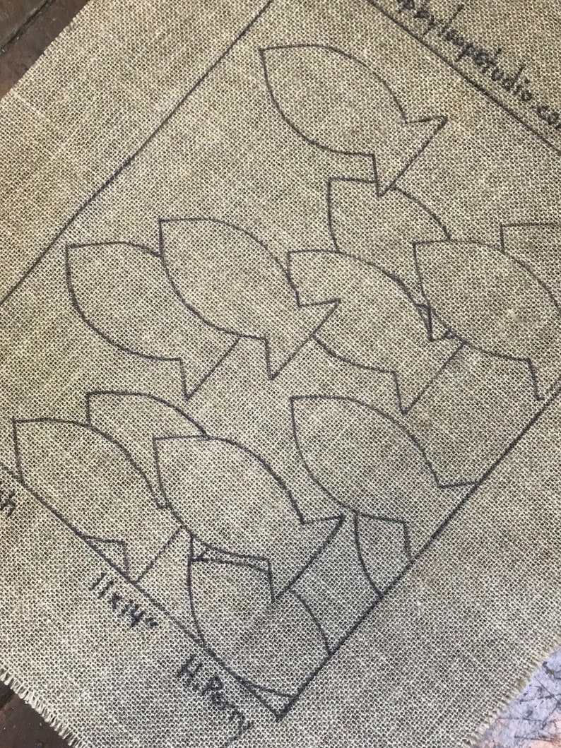 May include: A burlap fabric with a pattern of fish shapes printed on it. The fabric is labeled "11 1/4 in. Hi-Rise".