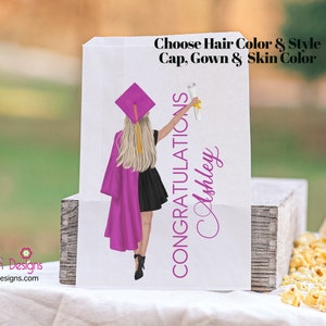 May include: A white graduation party favor bag with a pink and black illustration of a graduate holding a diploma. The text "CONGRATULATIONS Ashley" is printed on the bag. The text "Choose Hair Color & Style Cap, Gown & Skin Color" is printed at the top of the bag.