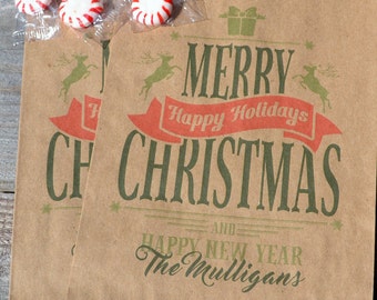May include: Two brown paper gift bags with a green and red Christmas design. The bags have the text "Merry Christmas and Happy New Year The Mulligans" printed on them.