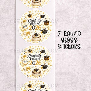 May include: A sheet of four 2-inch round gloss stickers. Each sticker features a graduation theme with a cake, mortarboard, diploma, and the text "Congrats Class of 2026". The design includes gold and white accents.