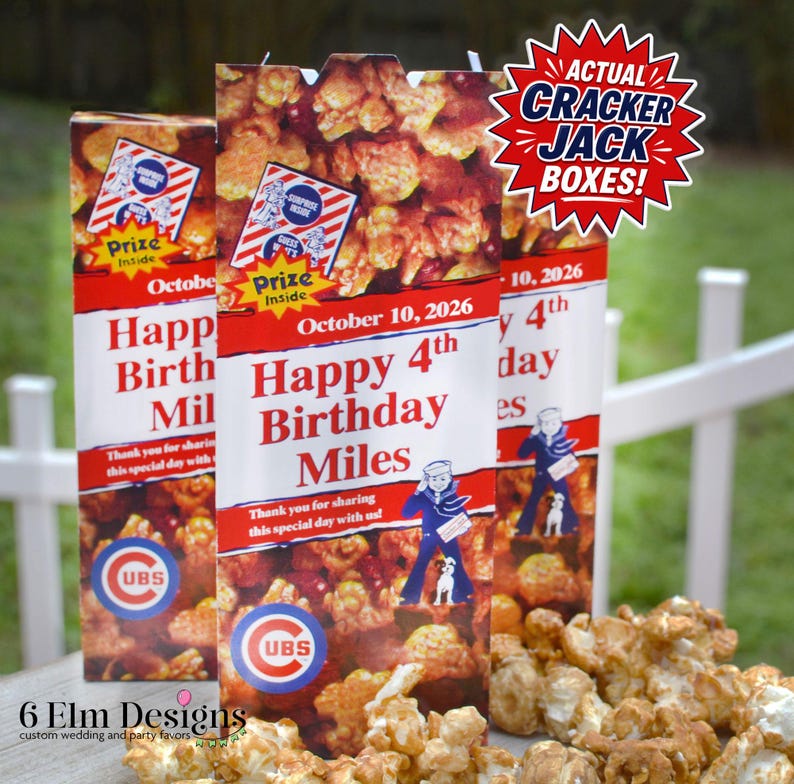 May include: Three custom Cracker Jack boxes with the text "Happy 4th Birthday Miles" and "October 10, 2026". The boxes feature a red and white design with a cartoon sailor and the Cubs logo. Caramel popcorn is in front.