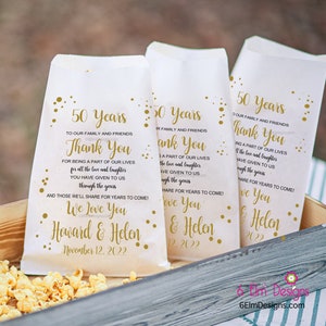 May include: Three white paper bags with gold polka dots and text. The bags have a thank you message for being a part of our lives for all the love and laughter you have given to us through the years. The bags also say "We love you Howard & Helen" and "November 12, 2022".