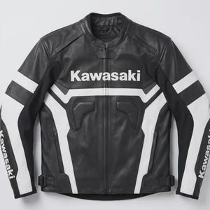 May include: A black and white leather motorcycle jacket featuring the Kawasaki logo printed in white across the chest and on both sleeves. The jacket has a full-length front zip, a mandarin collar with a snap tab, and adjustable waist straps.