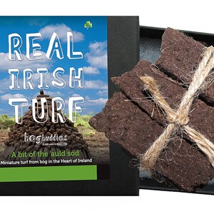 May include: A box of real Irish turf, a small stack of brown peat bricks tied with twine, with a label that reads "Real Irish Turf" and "A bit of the 'auld sod' Miniature turf from bog in the Heart of Ireland."