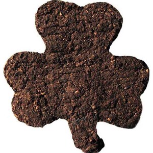 May include: A brown, three-leaf clover-shaped cookie made of soil.