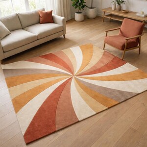May include: A large, rectangular rug with a spiral design in shades of orange, beige, and brown. The rug is placed on a wooden floor, and the design radiates from the centre. The rug is a decorative element for a living room.