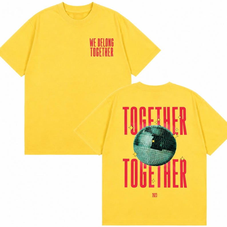 May include: Yellow t-shirt with red text that reads "WE BELONG TOGETHER" on the front and "TOGETHER" with a disco ball graphic on the back. The back also has the text "2023".