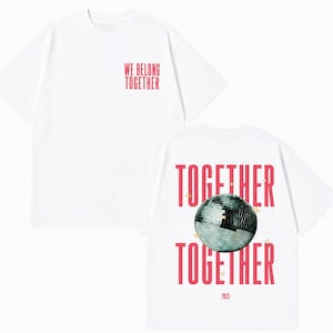 May include: White t-shirt with the text "WE BELONG TOGETHER" in red on the front. The back of the shirt features the words "TOGETHER" above and below a disco ball graphic, with the year "2023" below.