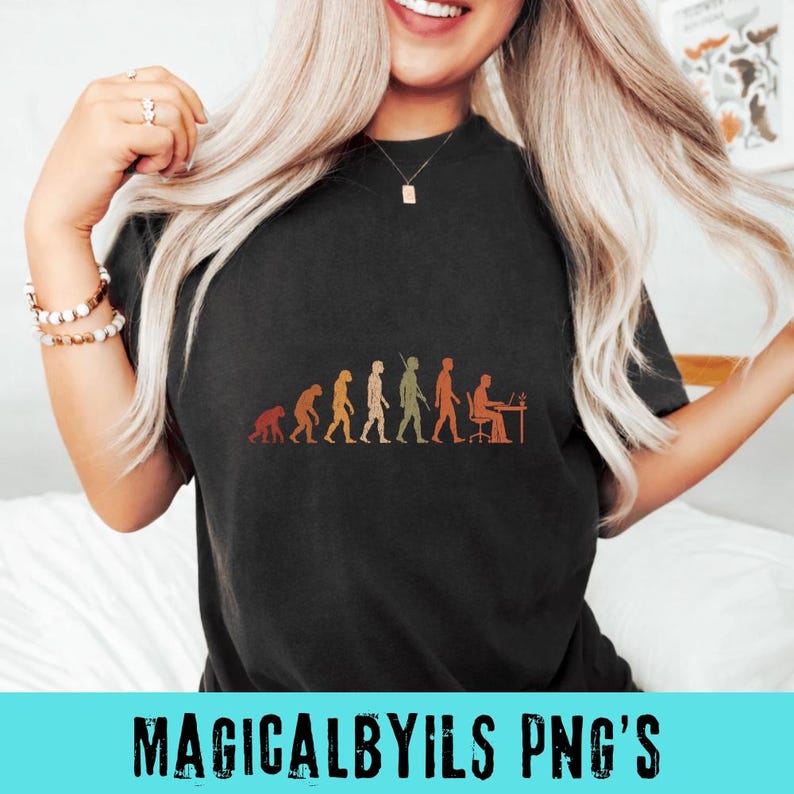 May include: A black short-sleeved t-shirt featuring a graphic print in orange and yellow tones. The design depicts the human evolution sequence, starting with a primate and progressing to a human figure sitting at a desk working on a computer.