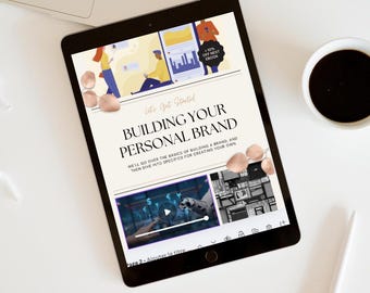 May include: A tablet displays a digital book titled "Building Your Personal Brand" with illustrations. The image includes a laptop, coffee, a pen, and text that reads "Social Media Success Instant Download PDF". The word "Bestseller" is also visible.