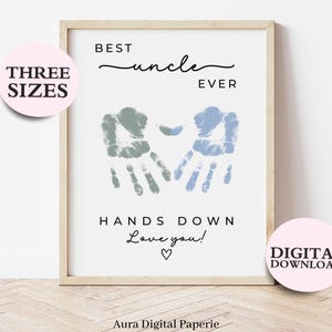 May include: Framed print with the text "BEST uncle EVER" and "HANDS DOWN Love you!" in black. Two handprints in blue and green are in the center. Pink circles with "THREE SIZES" and "DIGITAL DOWNLOAD" are on the left and right.
