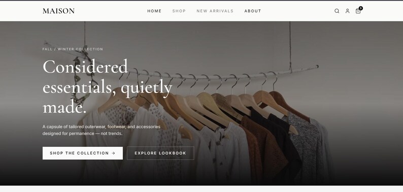 May include: A website landing page for Maison featuring a row of wooden hangers holding various garments. Text on the page reads: Fall / Winter Collection, Considered essentials, quietly made. A capsule of tailored outerwear, footwear, and accessories.