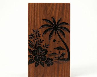 May include: A rectangular wooden box with a dark brown finish. The box features a black engraved design of a tropical beach scene with a palm tree, flowers, and a beach chair. The design is on the front of the box.