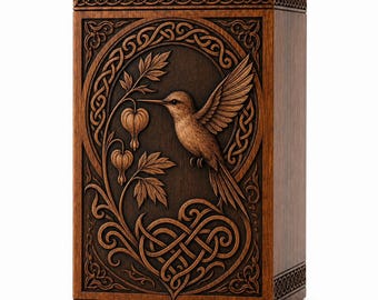 May include: A rectangular wooden urn featuring a detailed relief carving of a hummingbird hovering near bleeding heart flowers. The design is framed by an intricate Celtic knot border, with additional knotwork patterns at the top and bottom edges.