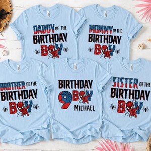 May include: Light blue t-shirts with various text designs for a birthday celebration. The shirts read "Daddy of the Birthday Boy," "Mommy of the Birthday Boy," "Brother of the Birthday Boy," "Birthday Boy 9 Michael," and "Sister of the Birthday Boy."