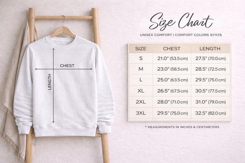 May include: A white crewneck sweatshirt hanging on a wooden hanger, accompanied by a size chart titled Size Chart Unisex Comfort Comfort Colors 17175. The chart lists chest and length measurements in inches from sizes S to 3XL for this garment.