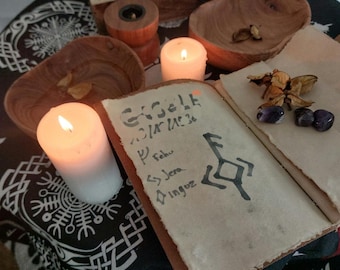 May include: An open book with handwritten text and symbols, lit by two candles. Wooden bowls and a small wooden box are also present. The scene is set on a patterned black and white cloth, creating a mystical ambiance.
