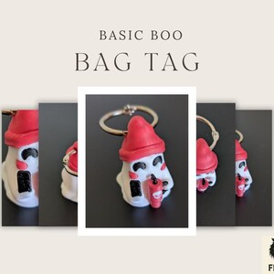 May include: A white ghost-shaped bag tag with a red hat and a small red cup. The tag has black eyes and a black mouth. The text "BASIC BOO BAG TAG" is at the top of the image.