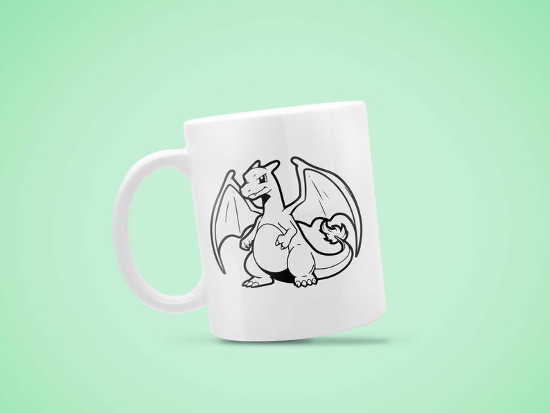 May include: White ceramic mug featuring a black and white illustration of a dragon with wings. The dragon is centered on the mug, with its wings spread. The mug has a curved handle and a smooth surface. The design is a cartoon style.