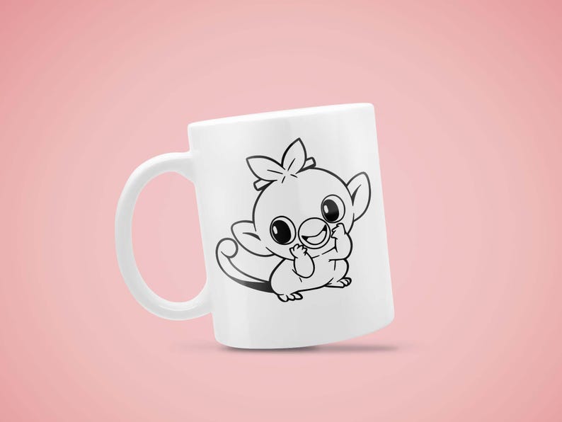 May include: White ceramic mug featuring a black and white cartoon illustration of a cute creature with large eyes and a playful expression. The mug has a curved handle and is set against a pink background.