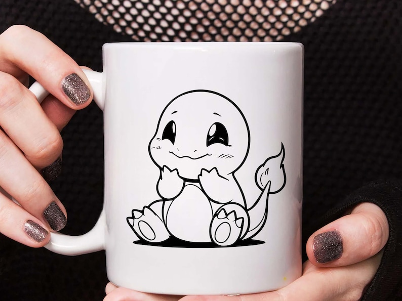 May include: White ceramic mug featuring a black and white illustration of a cartoon character. The character has a round head, large eyes, and a smiling expression. The mug is held by a person.
