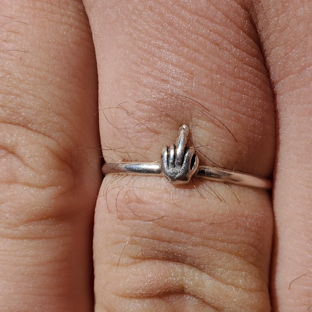 Engagement ring on sale in middle finger