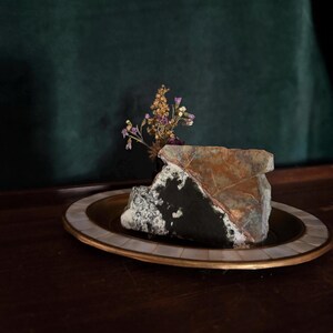 May include: A rustic wooden sign with the text "Welcome to our home" in white lettering. The sign features a distressed finish and a simple, inviting design, perfect for entryway decor.